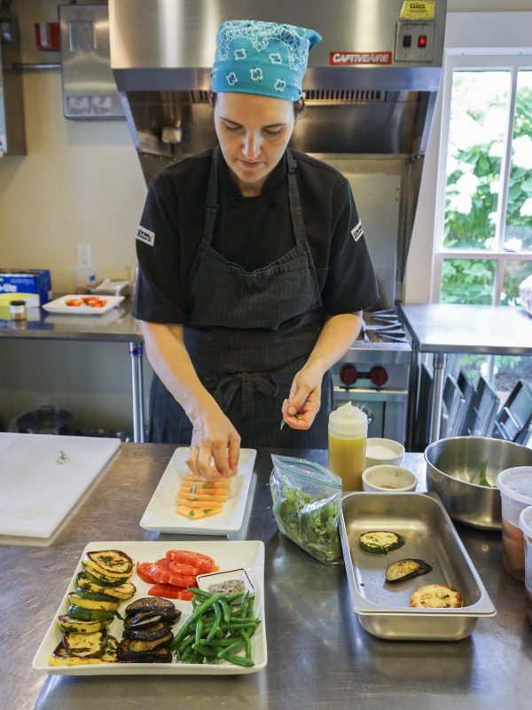 Chef Katie Porter garnishes a melon salad at The Wallace House. (Crystal Shi/Epoch Times)